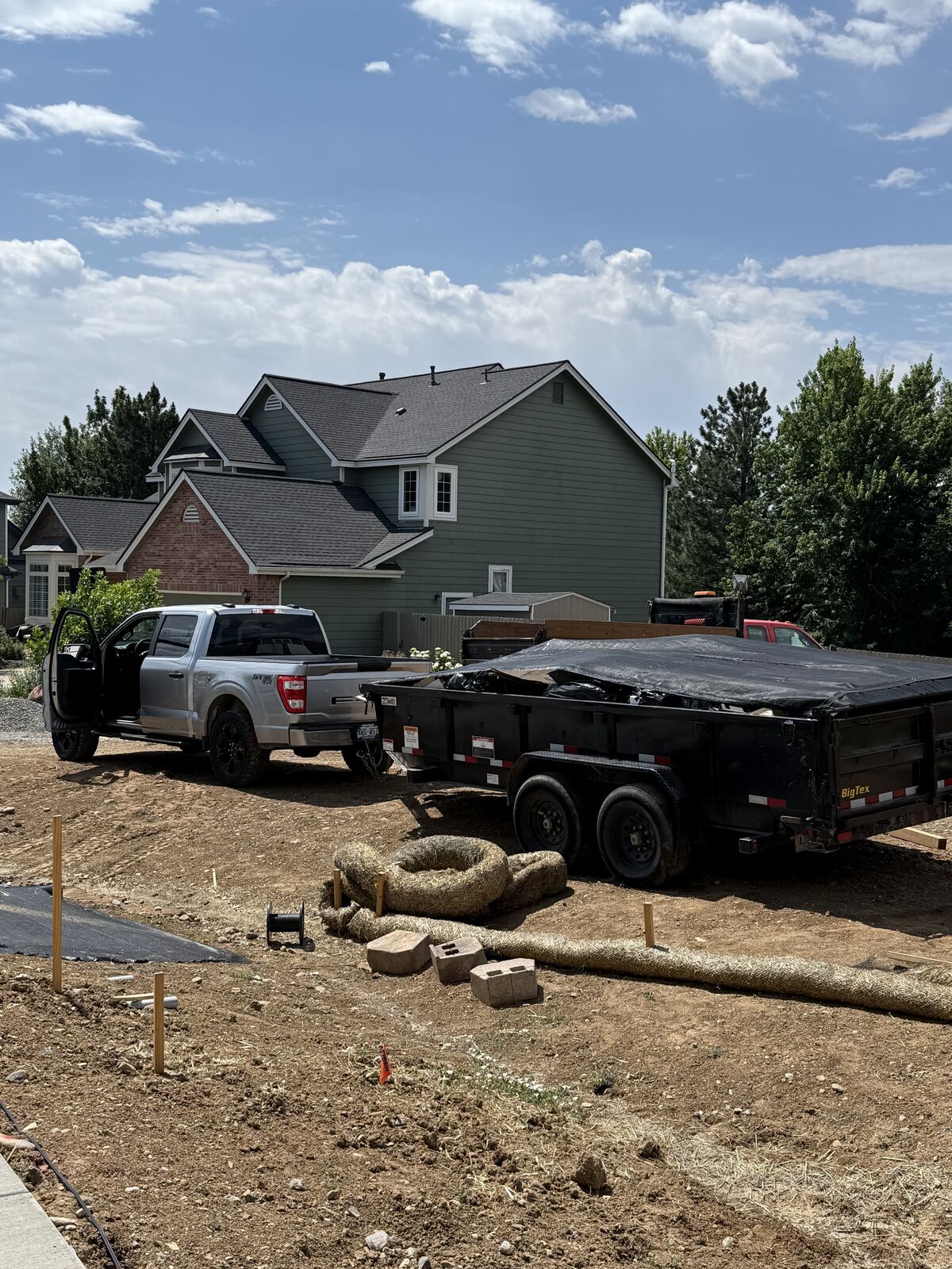 Sparks Home Services truck and dump trailer at a job site