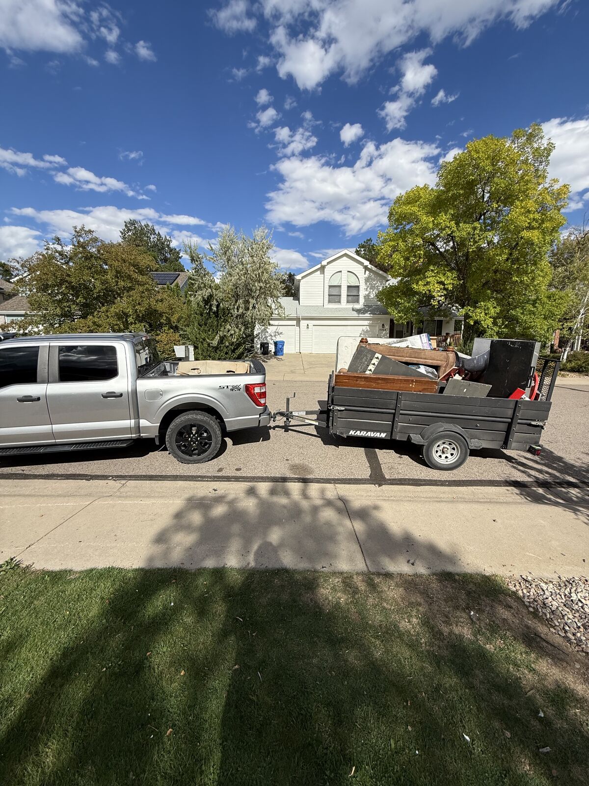 Sparks Home Services truck and loaded trailer at a Northern Colorado home